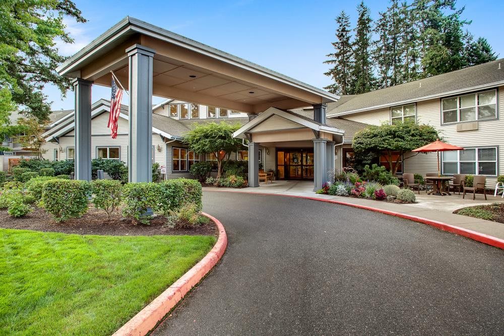 A welcoming entrance to a residential building with neatly landscaped surroundings.