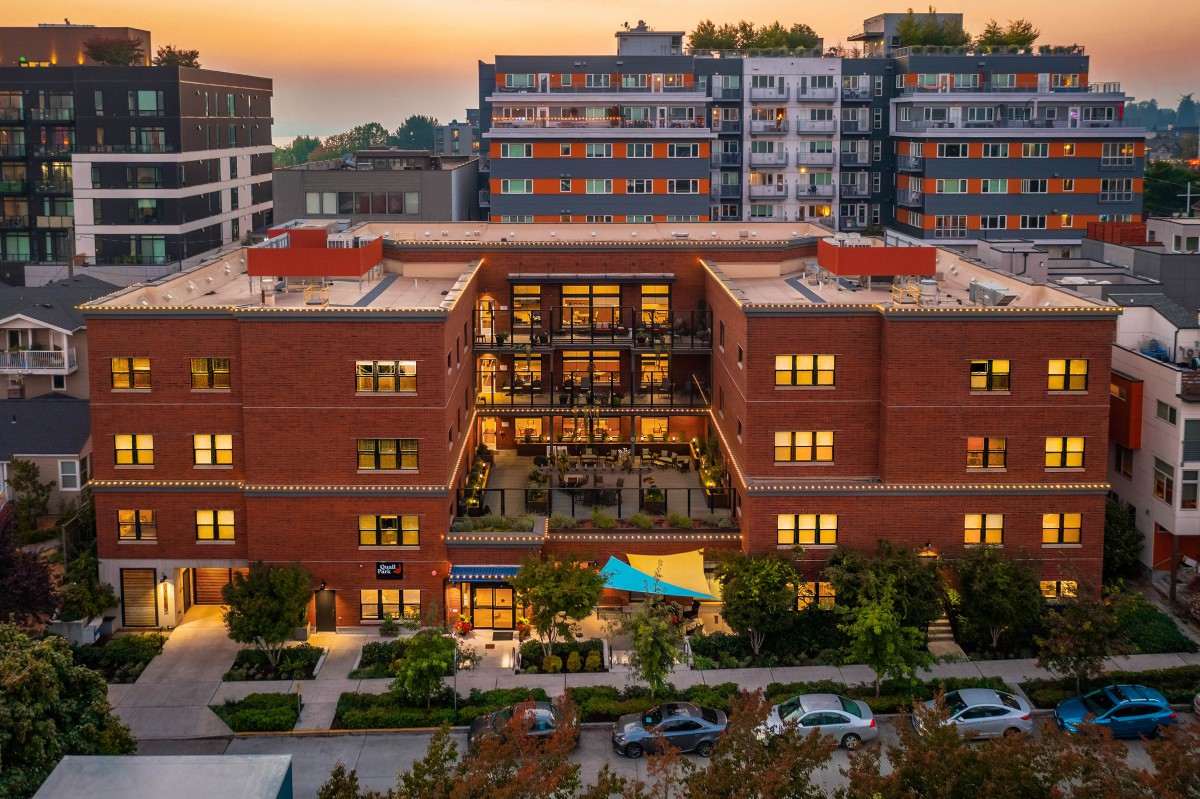 A vibrant urban apartment complex at sunset.