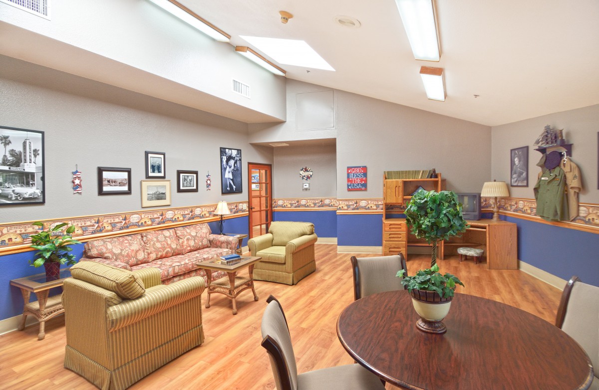 A cozy living space with comfortable seating, decorative wall art, and indoor plants.