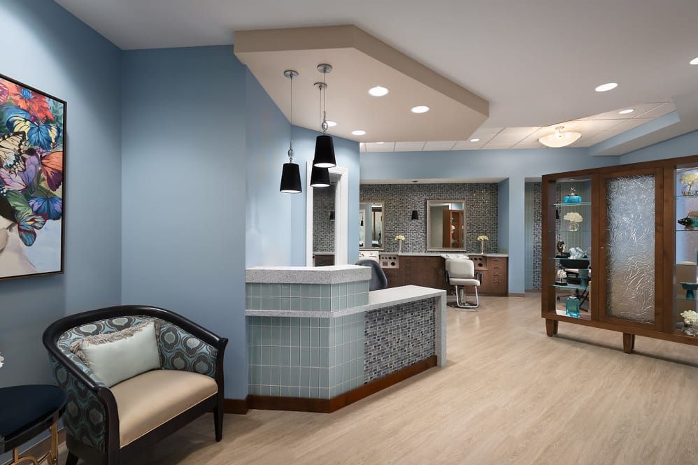 A modern reception area with blue walls and stylish pendant lighting.