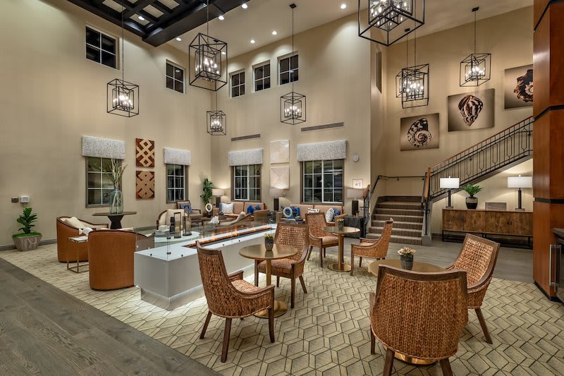 A modern lobby with stylish furniture and unique lighting fixtures.