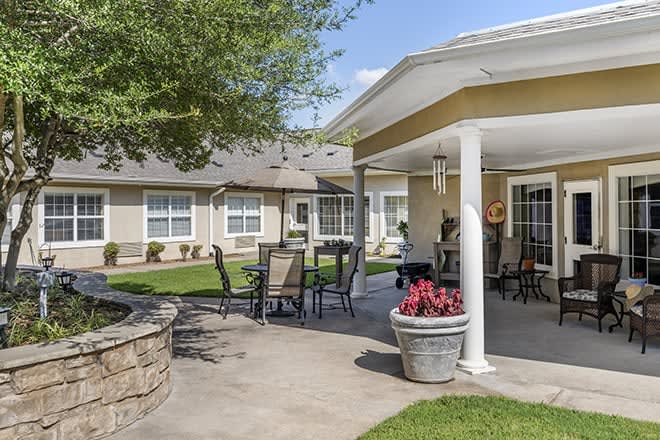 A well-maintained outdoor patio with seating and landscaping.