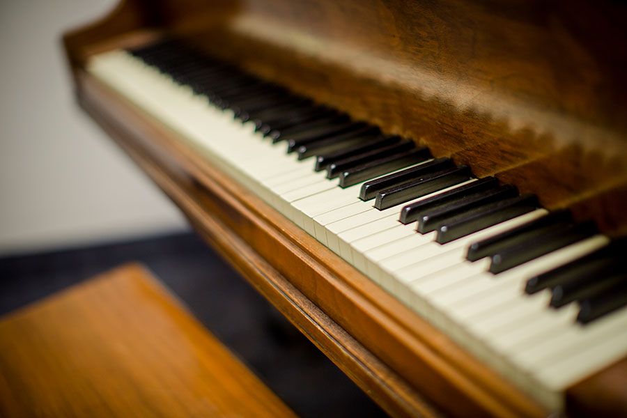 Close-up view of a wooden piano keyboard.