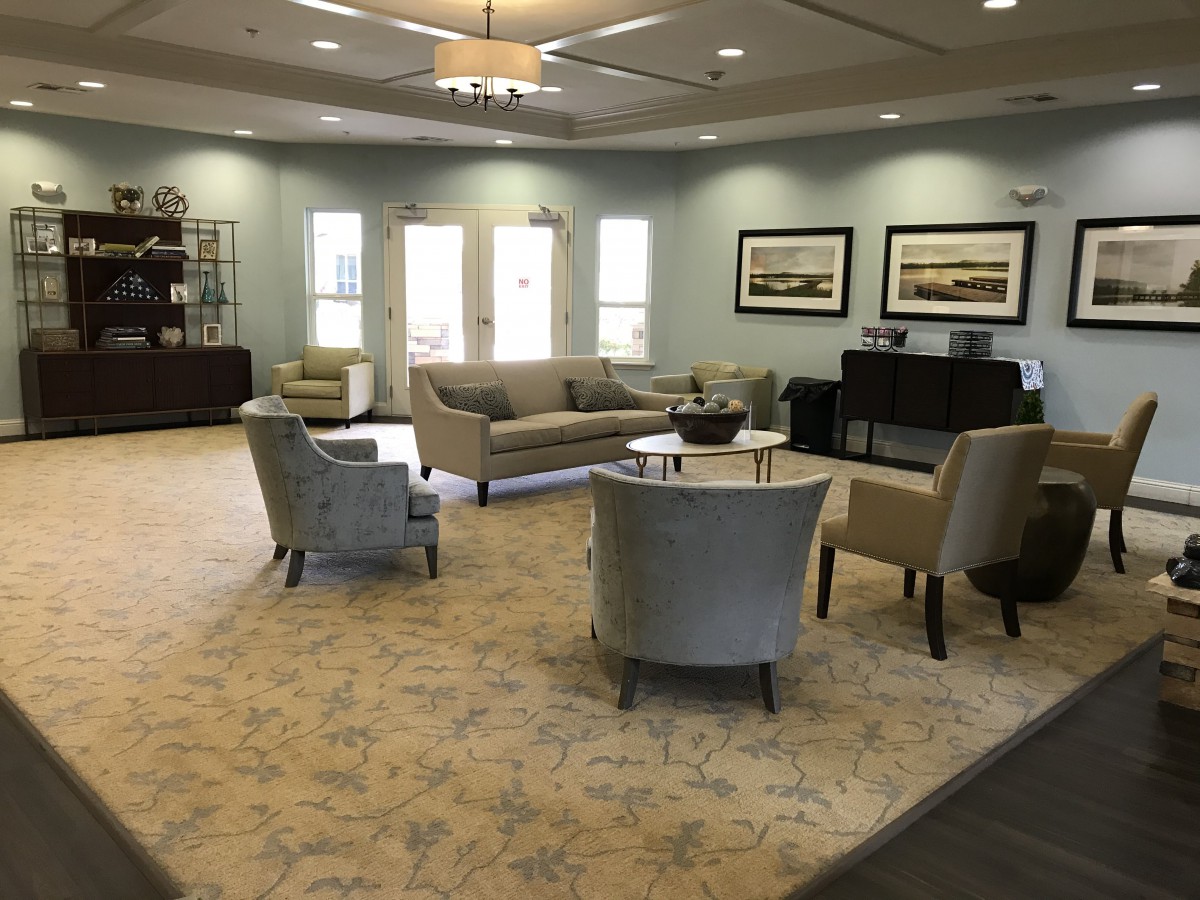 A spacious living room with comfortable seating and elegant decor.