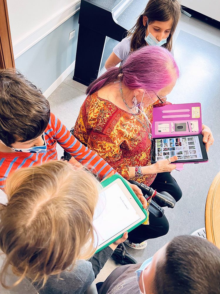 A group of children engaged in learning using tablets.
