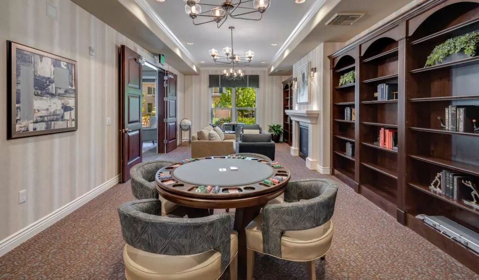 Luxurious lounge with a poker table and elegant decor.