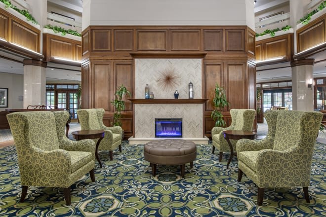 A luxurious hotel lobby with elegant seating arrangements and a fireplace.