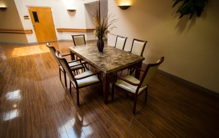 Elegant dining room with a large wooden table and upholstered chairs.