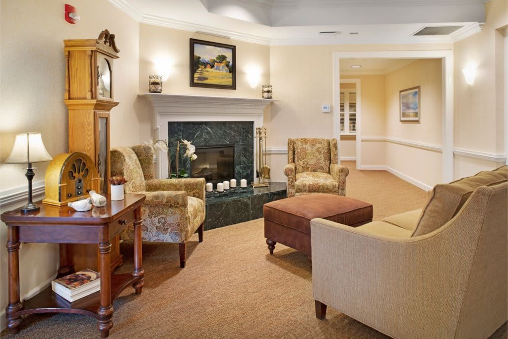 A cozy living room with a fireplace and traditional furnishings.