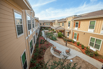 A view of a residential complex with a central courtyard and pathways.