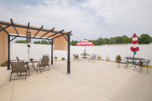 A spacious outdoor patio area with a pergola and shaded seating, perfect for leisurely moments.