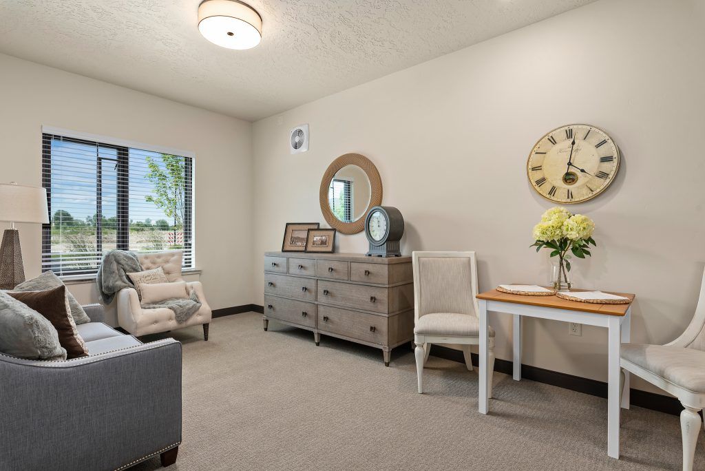 A cozy living room with a stylish dresser, comfortable seating, and elegant decor.