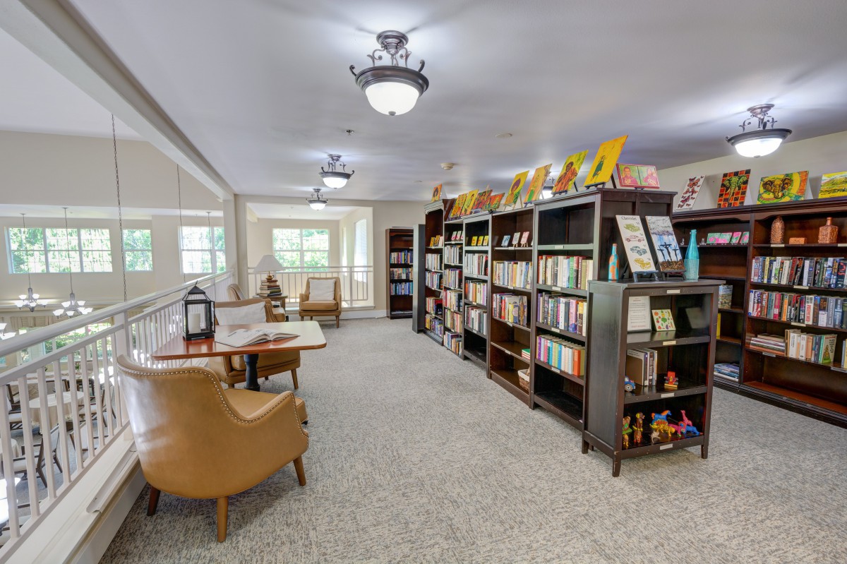 A cozy library interior with bookshelves and a reading area.