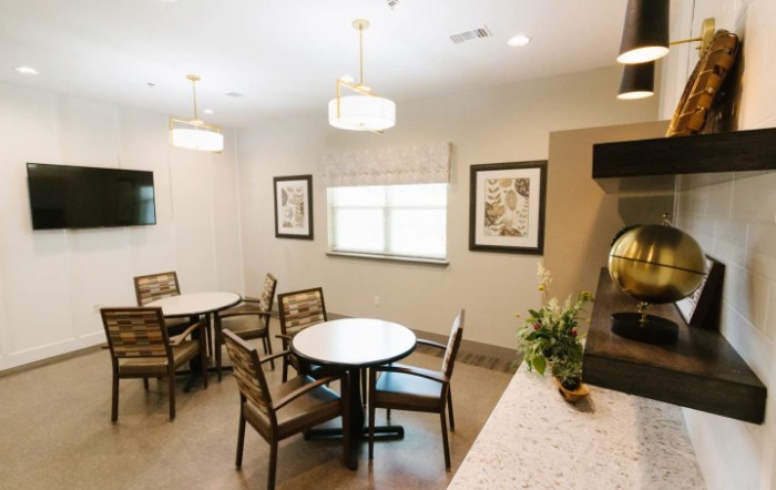 A cozy indoor dining area with tables, chairs, and decorative elements.