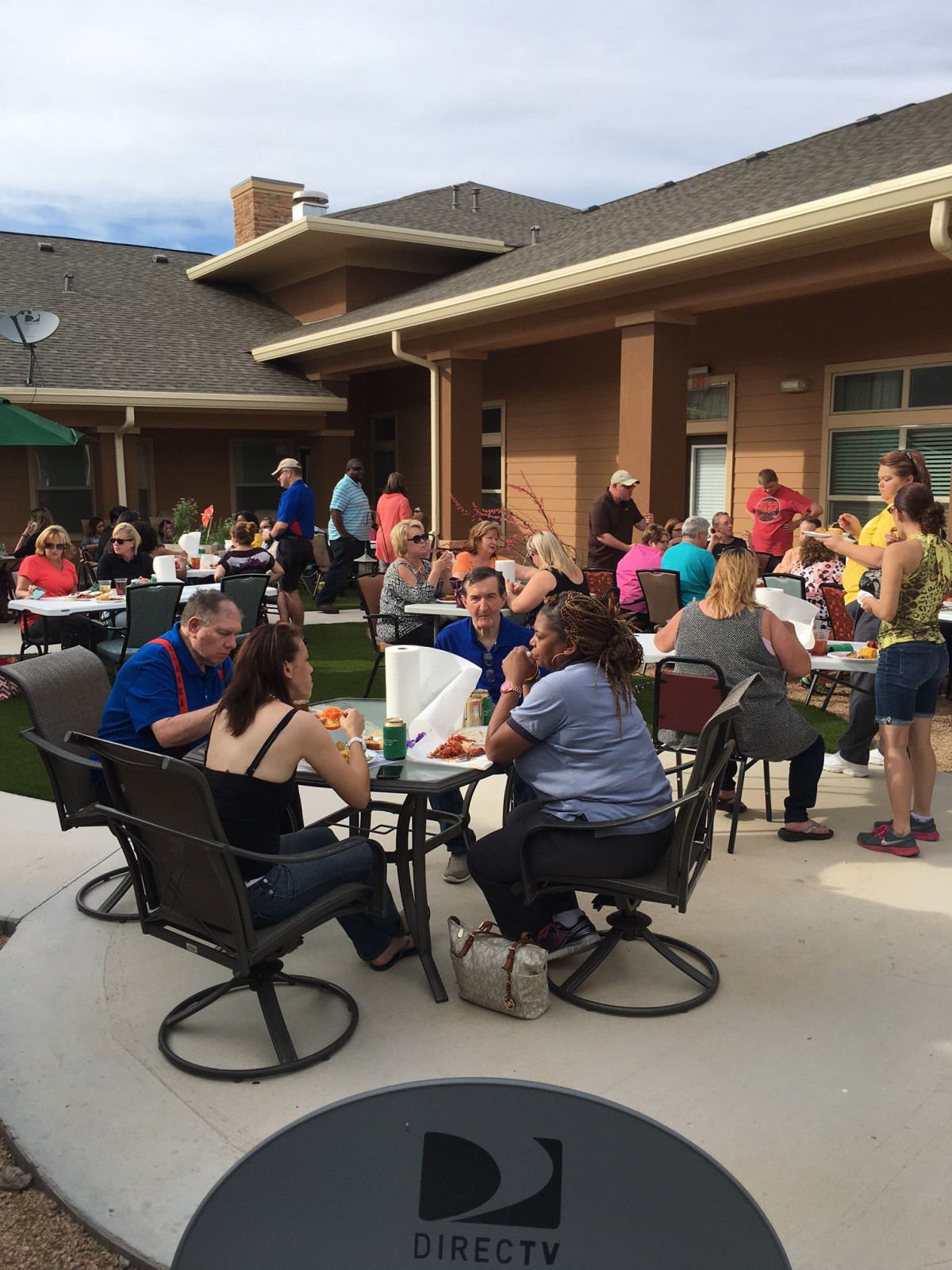 A social gathering on a patio with people enjoying each other's company outdoors.