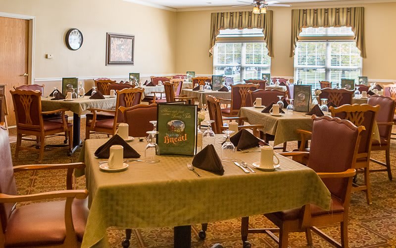 A well-organized dining area with neatly arranged tables and chairs, ready for guests.