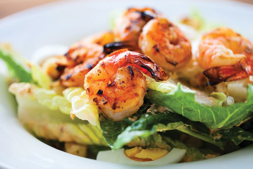 Grilled shrimp served on a fresh bed of lettuce.