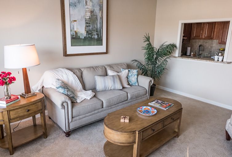 A cozy living room with a comfortable sofa, stylish coffee table, and decorative artwork.
