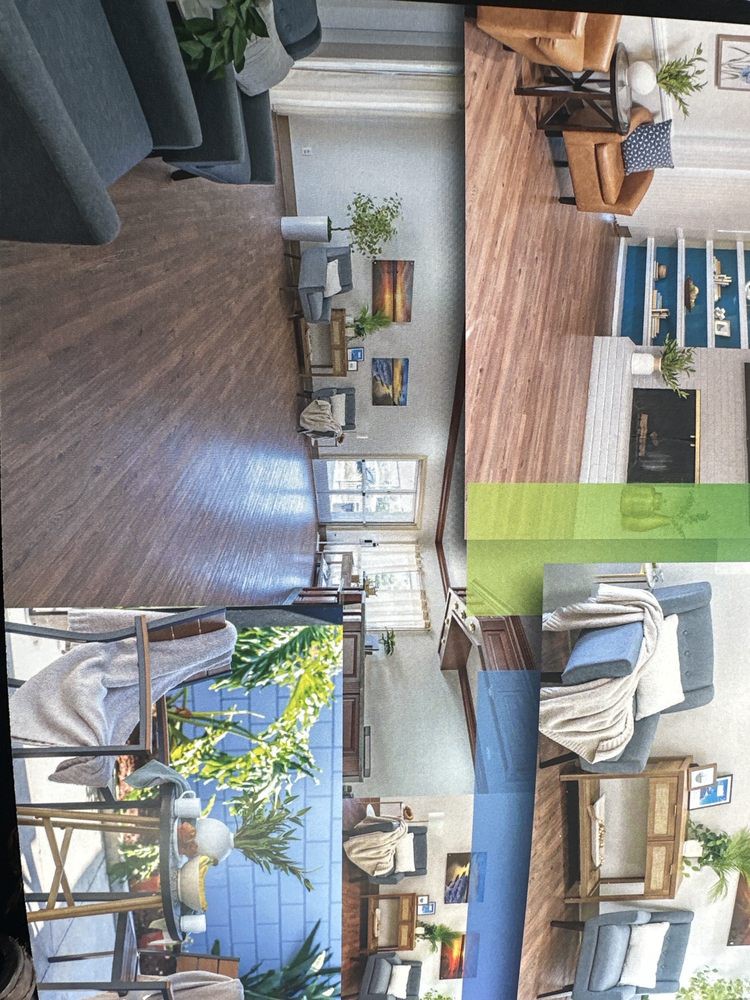 A stylish and cozy living room with wood flooring, a fireplace, and plenty of natural light.
