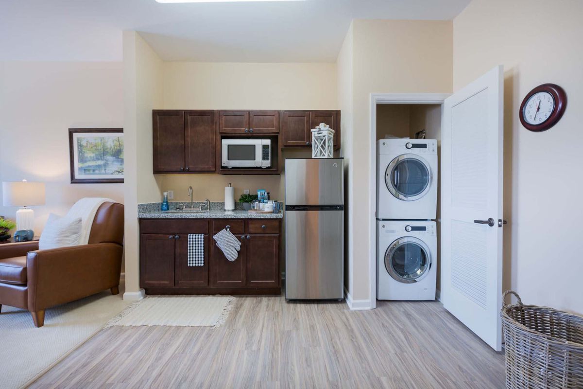 Modern compact kitchen with integrated laundry appliances.