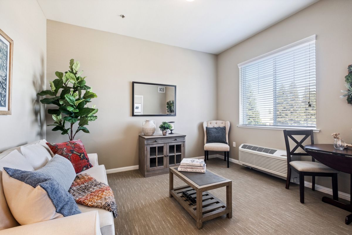 A cozy living room with a sofa, coffee table, and decorative elements.