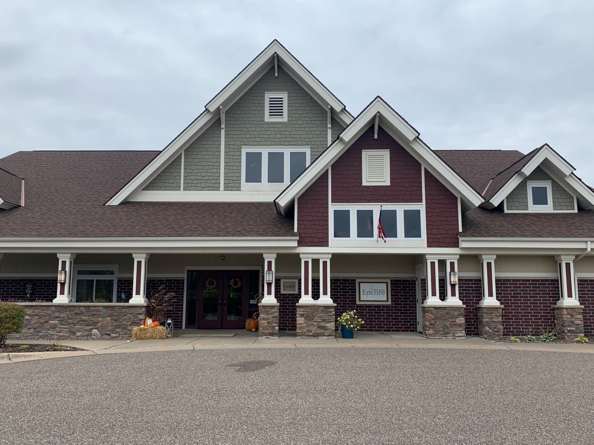 A modern suburban house with a garage and unique architectural features.