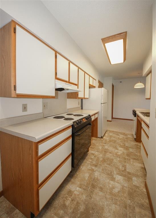A modern kitchen with ample cabinet space and standard appliances.