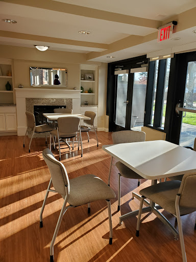 A cozy lounge area featuring modern furniture and ample natural light.
