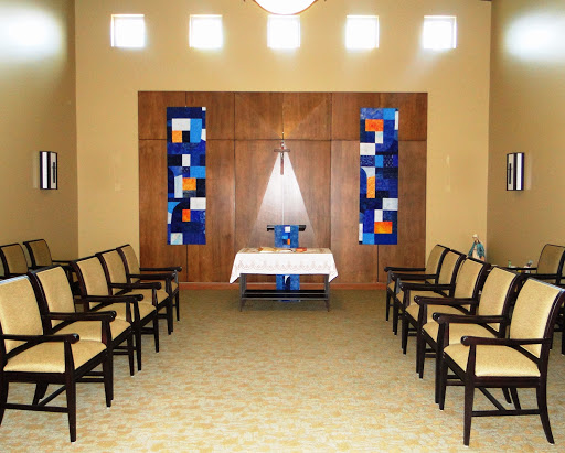 A serene waiting area featuring comfortable chairs and decorative artwork.