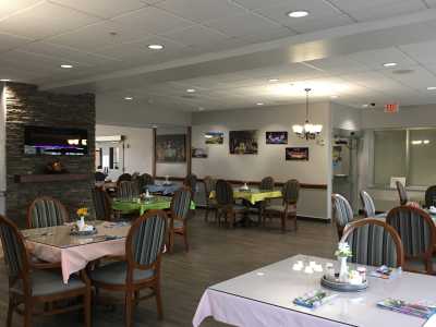 A cozy dining area with neatly arranged tables and chairs, featuring a casual and welcoming atmosphere.