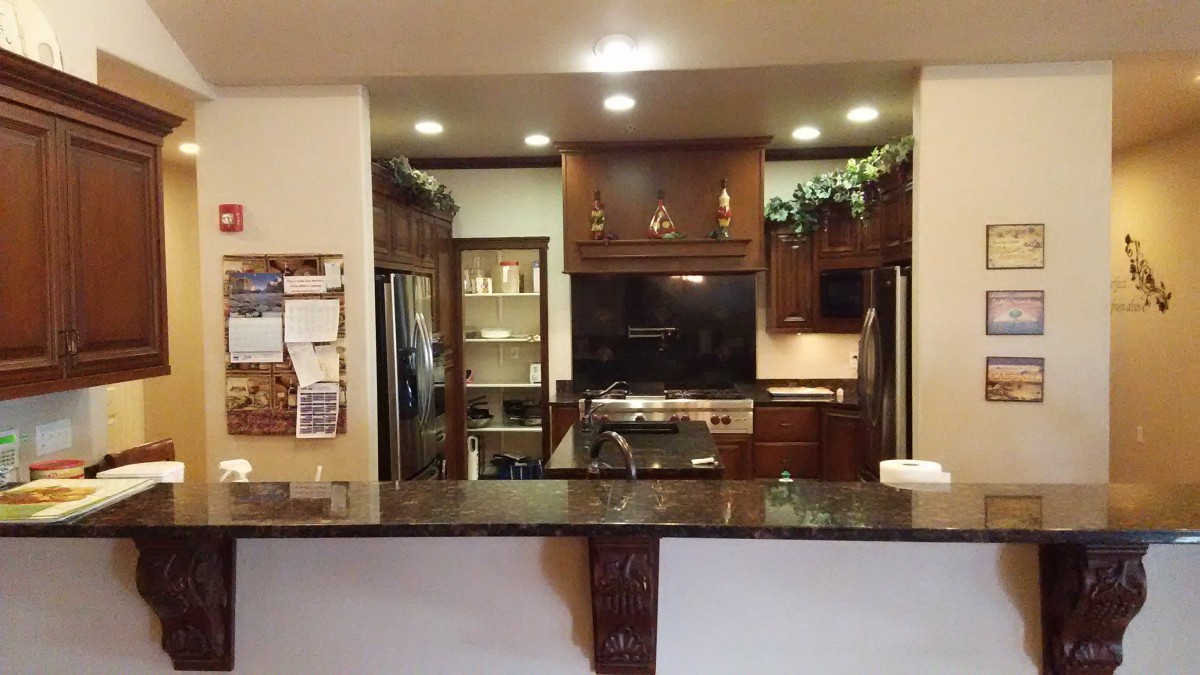 A modern kitchen with wooden cabinets and stainless steel appliances.
