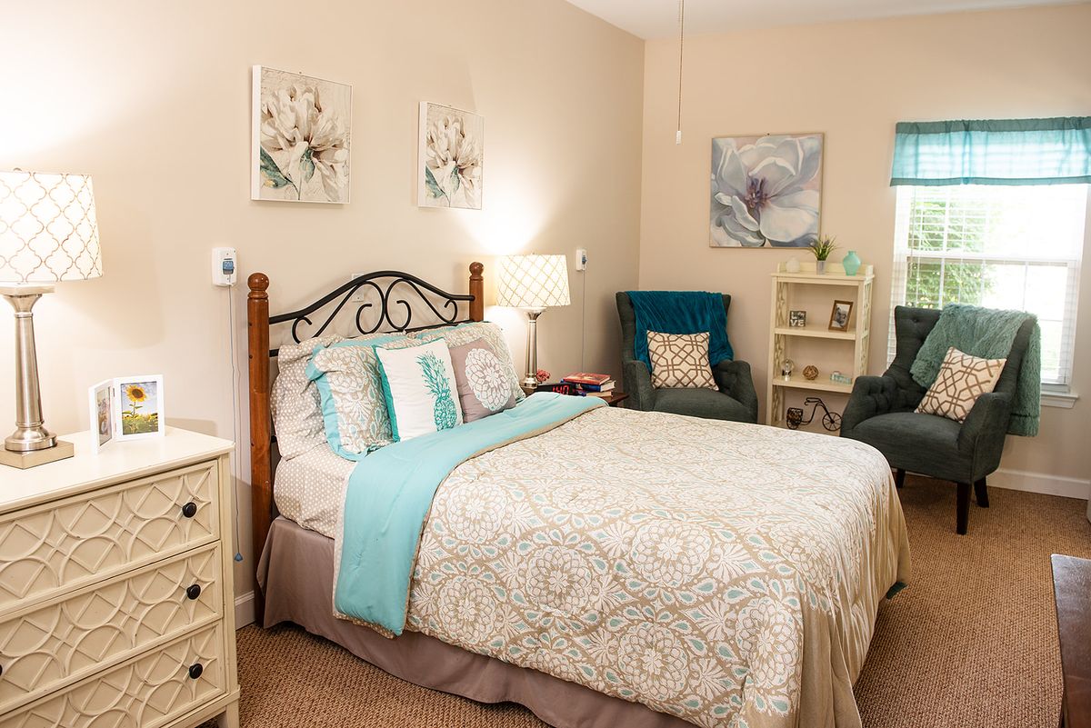 A cozy bedroom featuring a comfortable bed, elegant decor, and soft lighting.