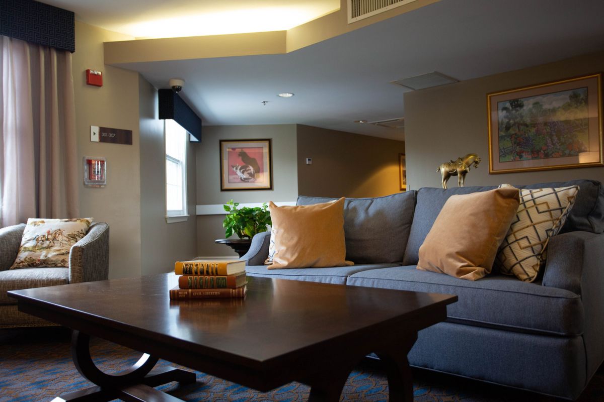 A cozy living room with a modern design, featuring a comfortable sofa, decorative pillows, and a wooden coffee table.