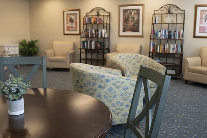 A cozy sitting area with comfortable chairs and bookshelves.