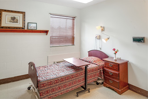 A cozy hospital room featuring two beds, designed for patient comfort and care.