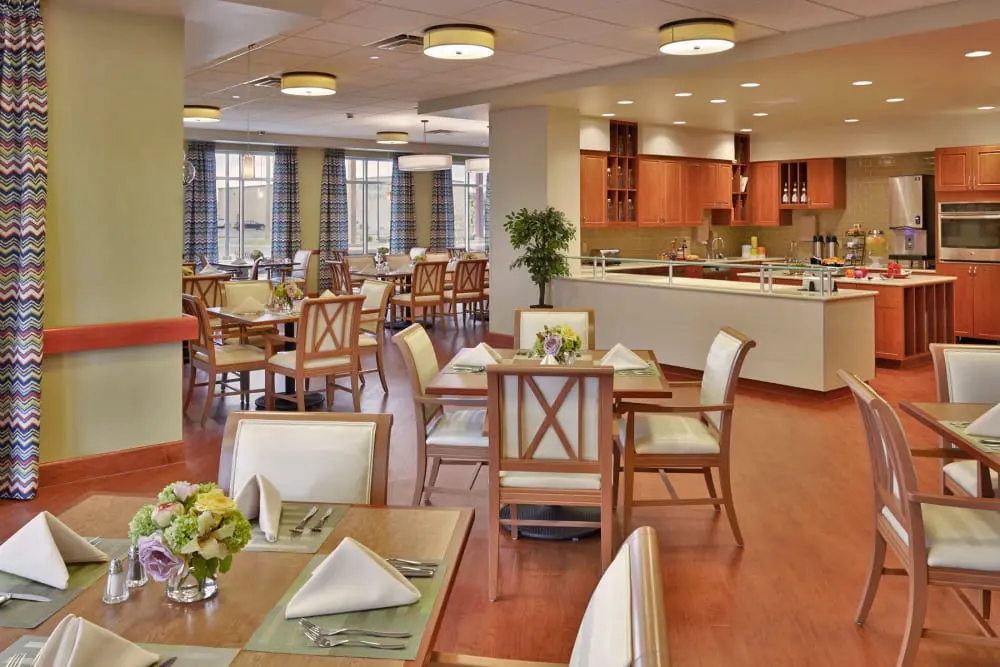 A modern restaurant interior with neatly arranged tables and chairs.