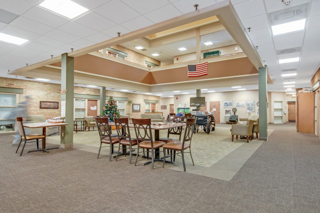 A spacious interior dining area featuring multiple tables and chairs, with ample lighting and decor.