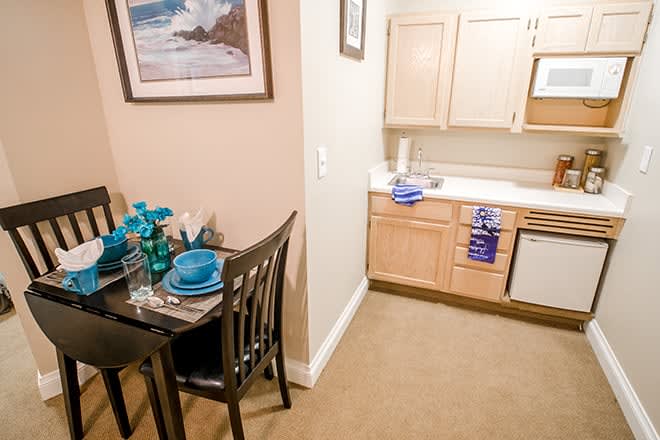 A cozy kitchen and dining area with a neatly arranged table setting.