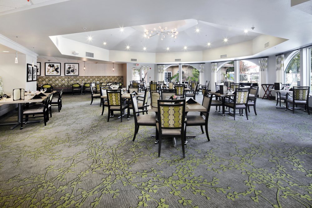 A spacious and modern dining area with neatly arranged tables and chairs.