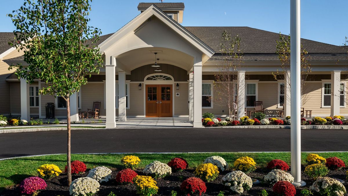 A well-maintained building entrance with colorful landscaping.