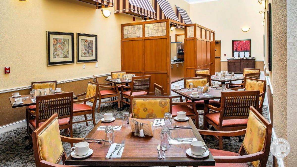 A cozy restaurant dining area with neatly set tables and chairs.