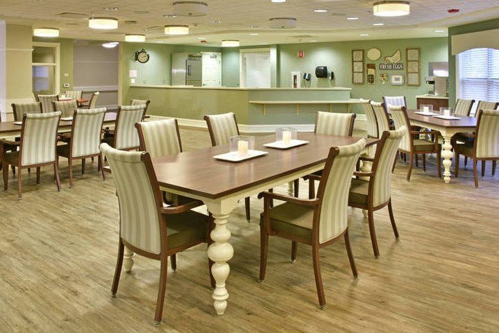 A well-lit dining area with neatly arranged tables and chairs.