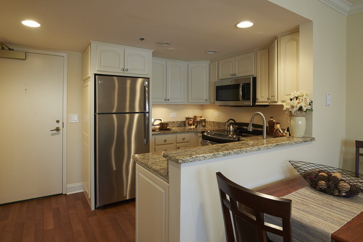 A modern kitchen with stainless steel appliances and granite countertops.