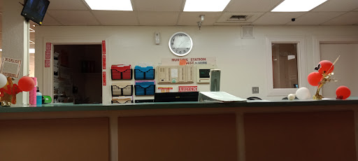 A view of a reception area featuring various mailboxes and a wall clock.