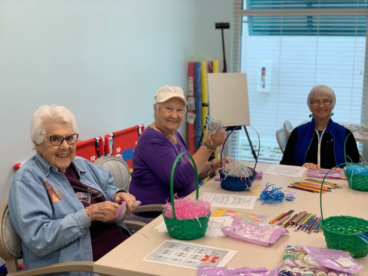 Group of seniors enjoying a crafting session at a community center.
