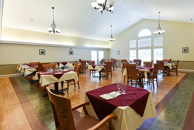 An elegant restaurant dining area with neatly arranged tables and chairs, ready for guests.