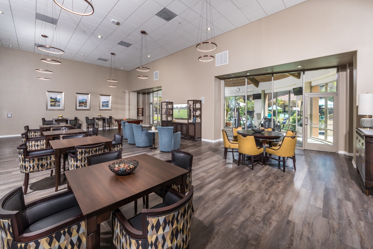 A modern dining area with wooden flooring and stylish furniture.