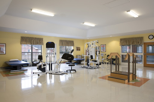 A spacious and well-equipped gym designed for fitness and rehabilitation.