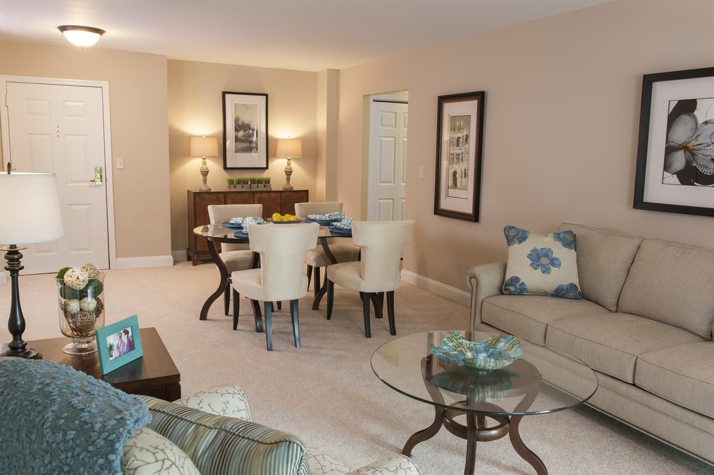 A cozy living room with an adjoining dining area, featuring elegant furniture and tasteful decor.