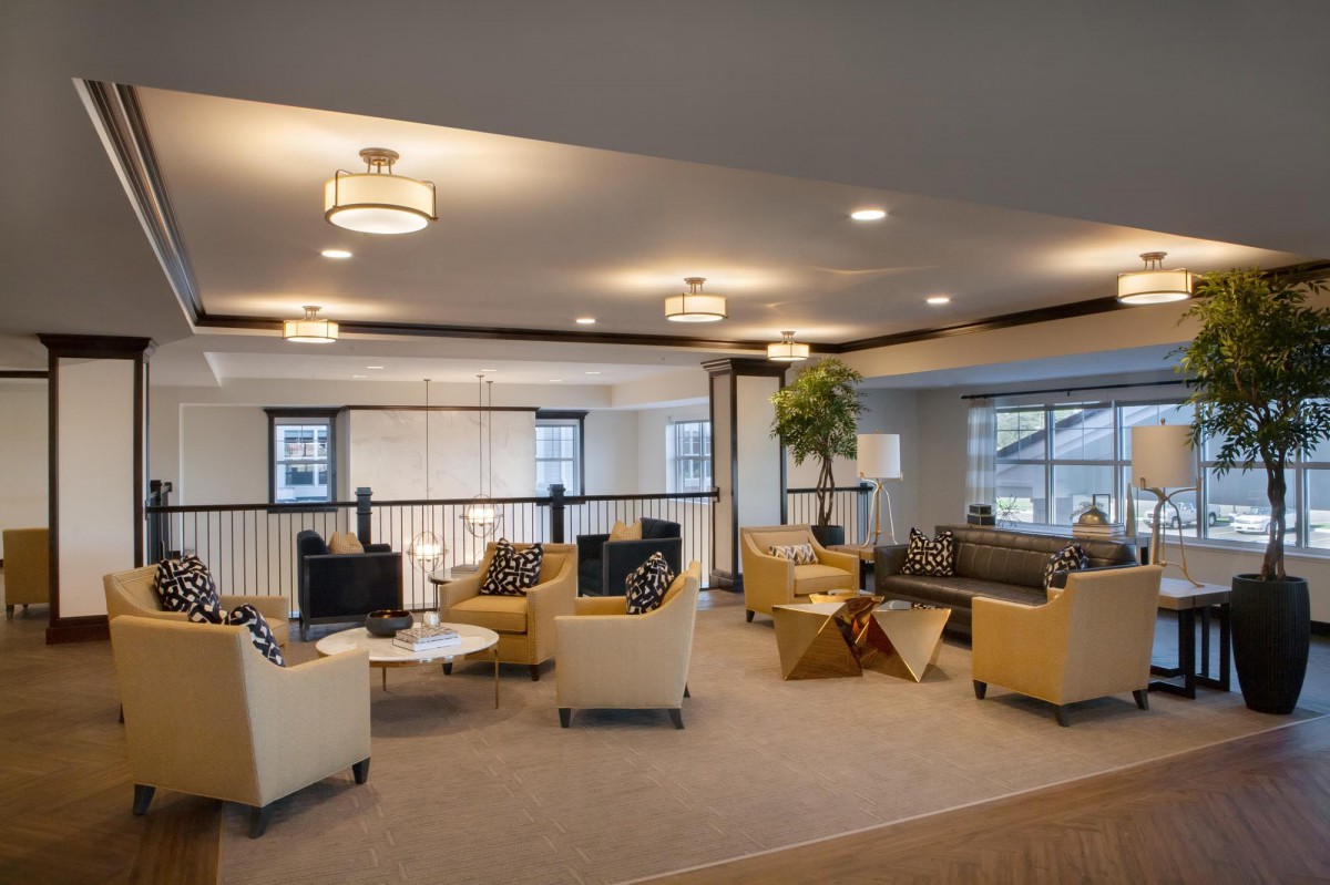 A modern lounge area featuring comfortable seating and bright lighting.